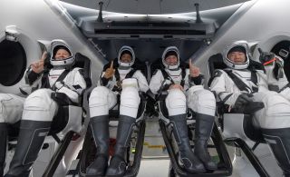 Left to right: NASA astronauts Shannon Walker, Victor Glover, and Mike Hopkins, and JAXA astronaut Soichi Noguchi inside the SpaceX Crew Dragon.