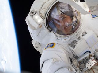 astronaut in spacesuit with blue earth bending to the side